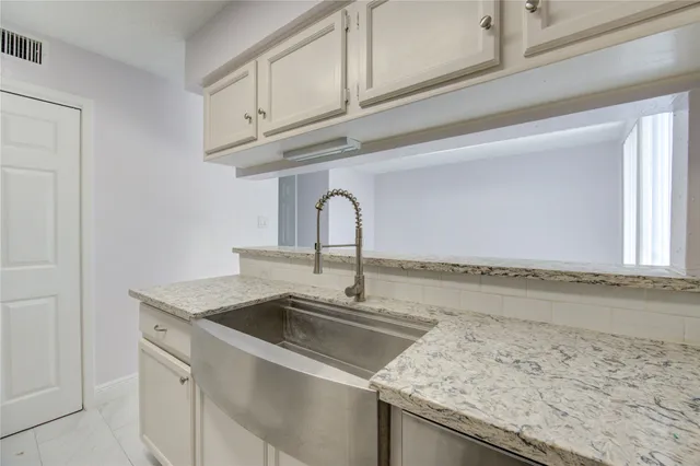 a kitchen with a sink and a refrigerator