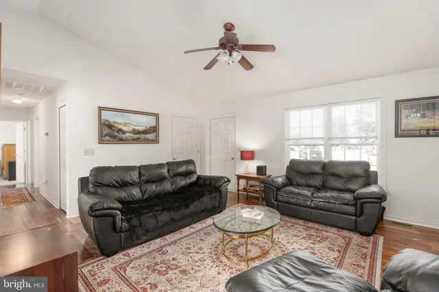a living room with furniture a rug and a window