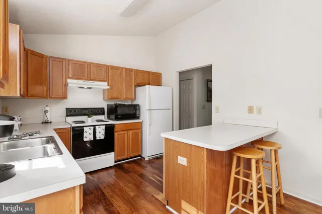 a kitchen with a sink a stove and refrigerator