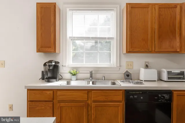 a kitchen with sink cabinets and window