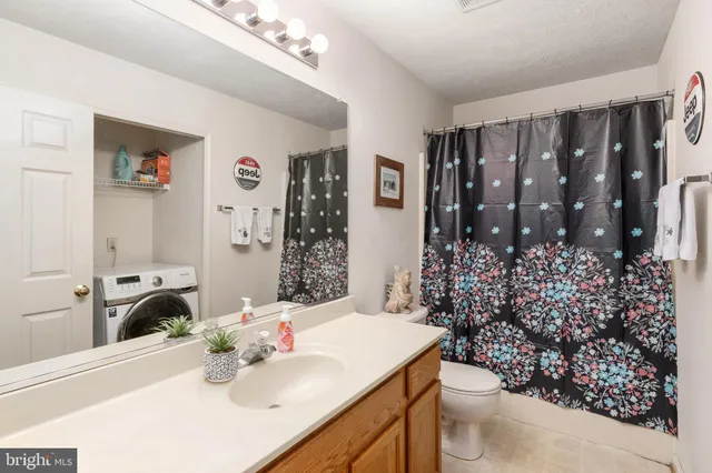 a view of storage and utility room with washer and dryer