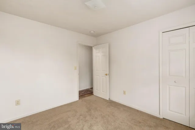 a bedroom with a bed couch and a window