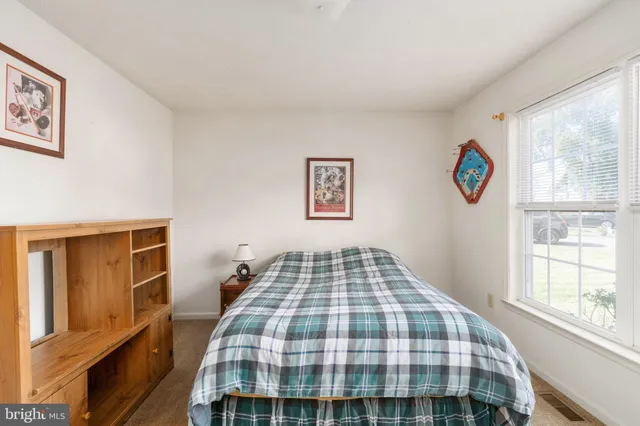 a bedroom with a bed and a chair