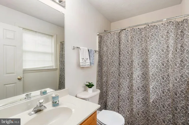 a white toilet sitting next to a bathroom sink