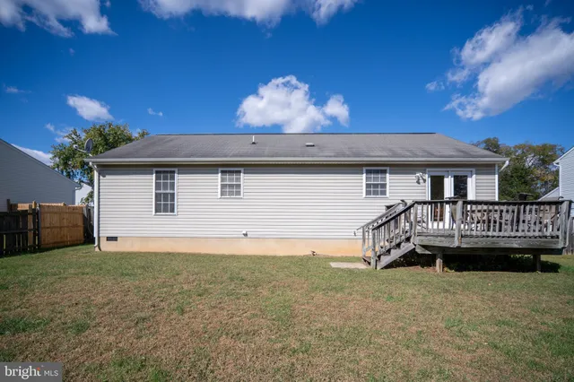 a view of a house with a yard and a garage