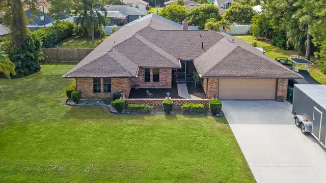 an aerial view of a house with swimming pool table and chairs