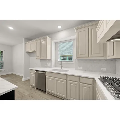 a kitchen with kitchen island a sink stainless steel appliances and cabinets