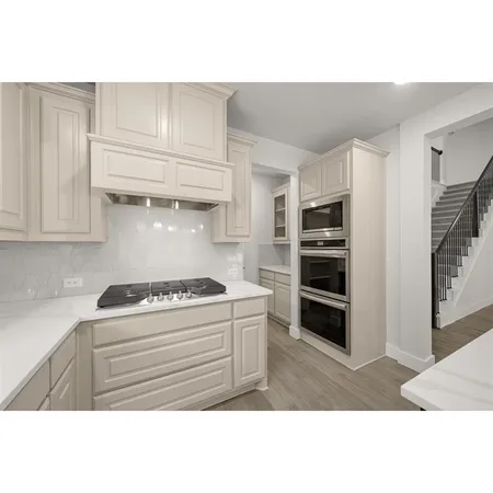 a view of a hallway with wooden floor and a window