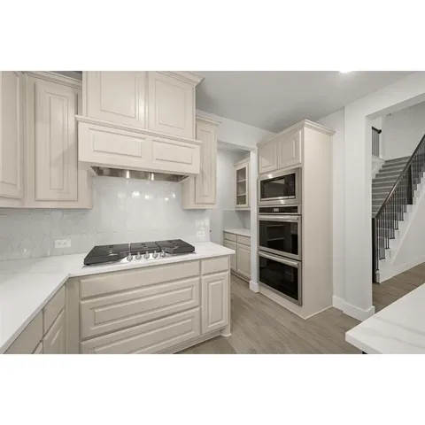 a view of a hallway with wooden floor and a window
