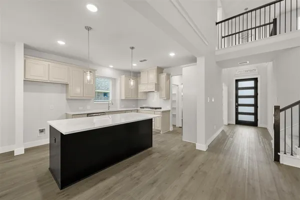 a kitchen with stainless steel appliances granite countertop a sink stove and cabinets