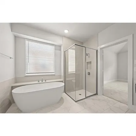 a bathroom with a tub sink shower and a mirror