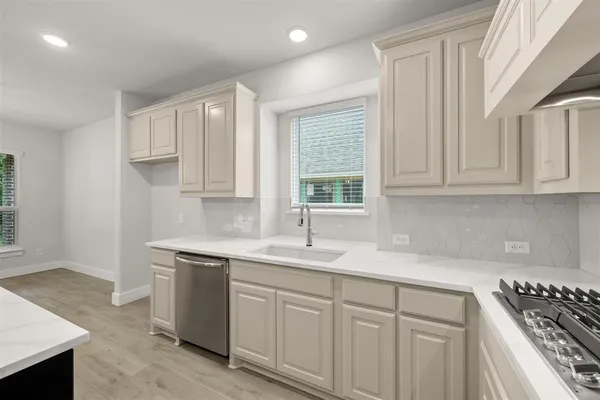 a kitchen with stainless steel appliances a stove and a refrigerator