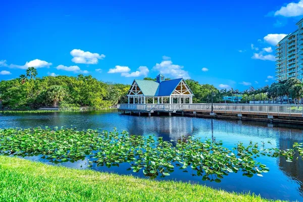 a view of a lake with sitting area and swimming pool