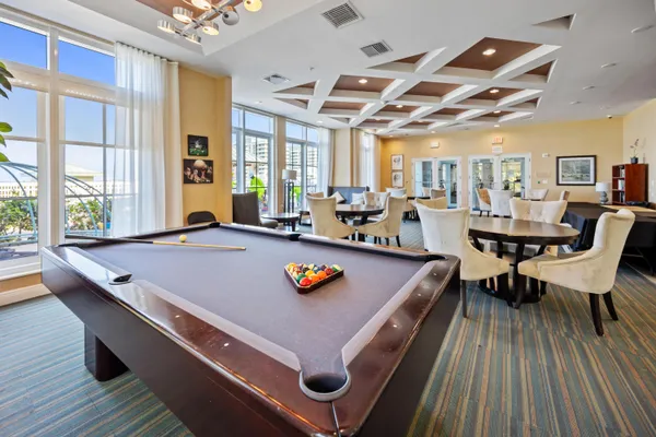a living room with stainless steel appliances kitchen island granite countertop furniture and a large window