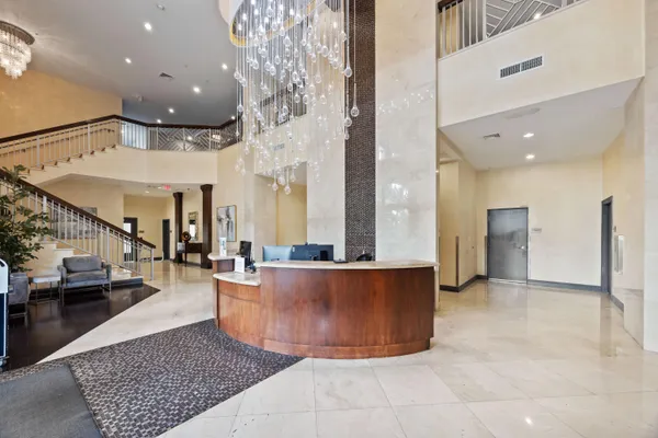 a living room with couches and kitchen view with wooden floor