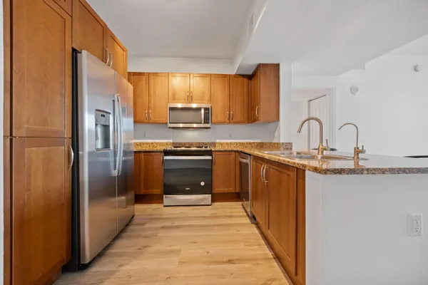 a kitchen with stainless steel appliances a refrigerator sink and cabinets
