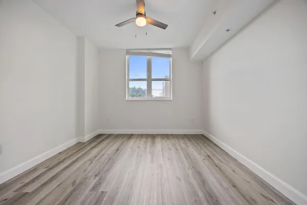 wooden floor in an empty room with a window
