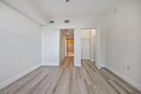 a view of a room with wooden floor