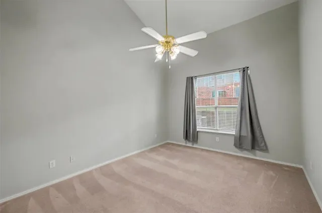 en empty room with windows and fan