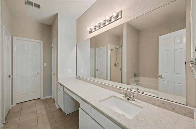 a bathroom with a sink double vanity and a mirror