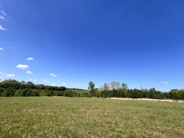 a view of a building with a field