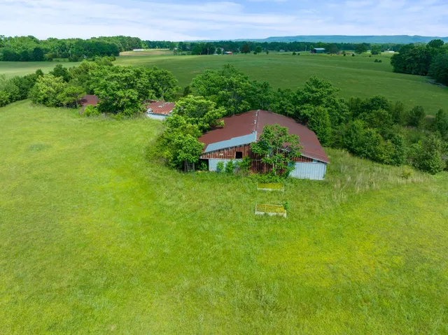 an aerial view of a house with a garden and lake view