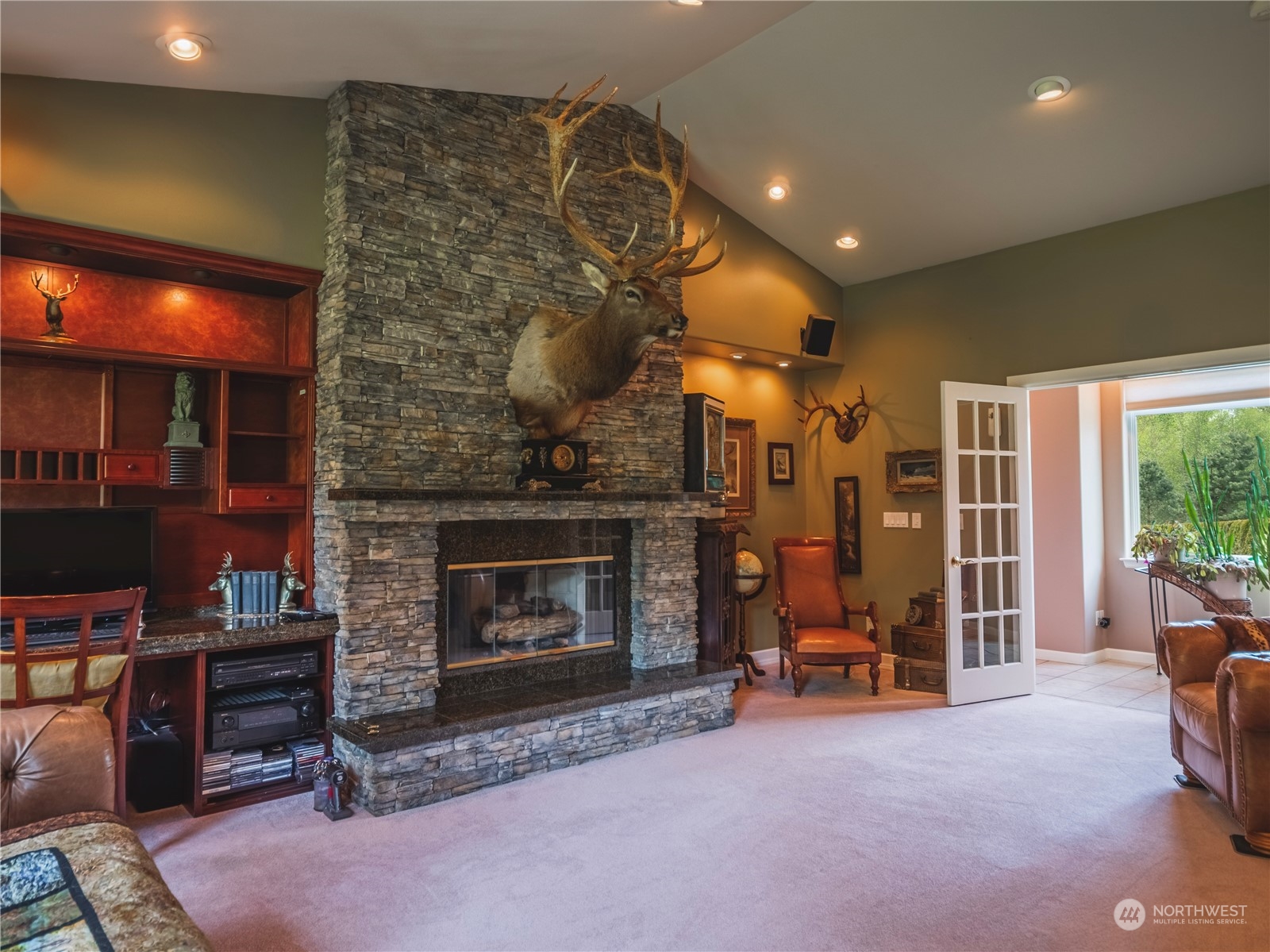 7801 Westlund Road Arlington, WA 98223 - Photo 14 of 39 a living room with furniture a flat screen tv and a fireplace