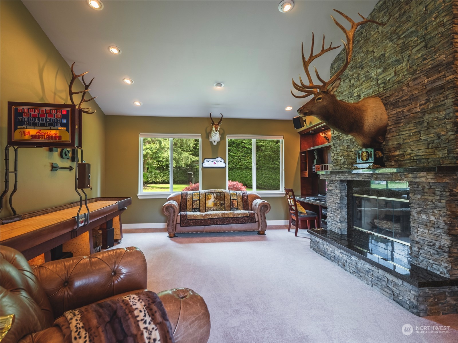 7801 Westlund Road Arlington, WA 98223 - Photo 15 of 39 a living room with furniture a fireplace and a floor to ceiling window
