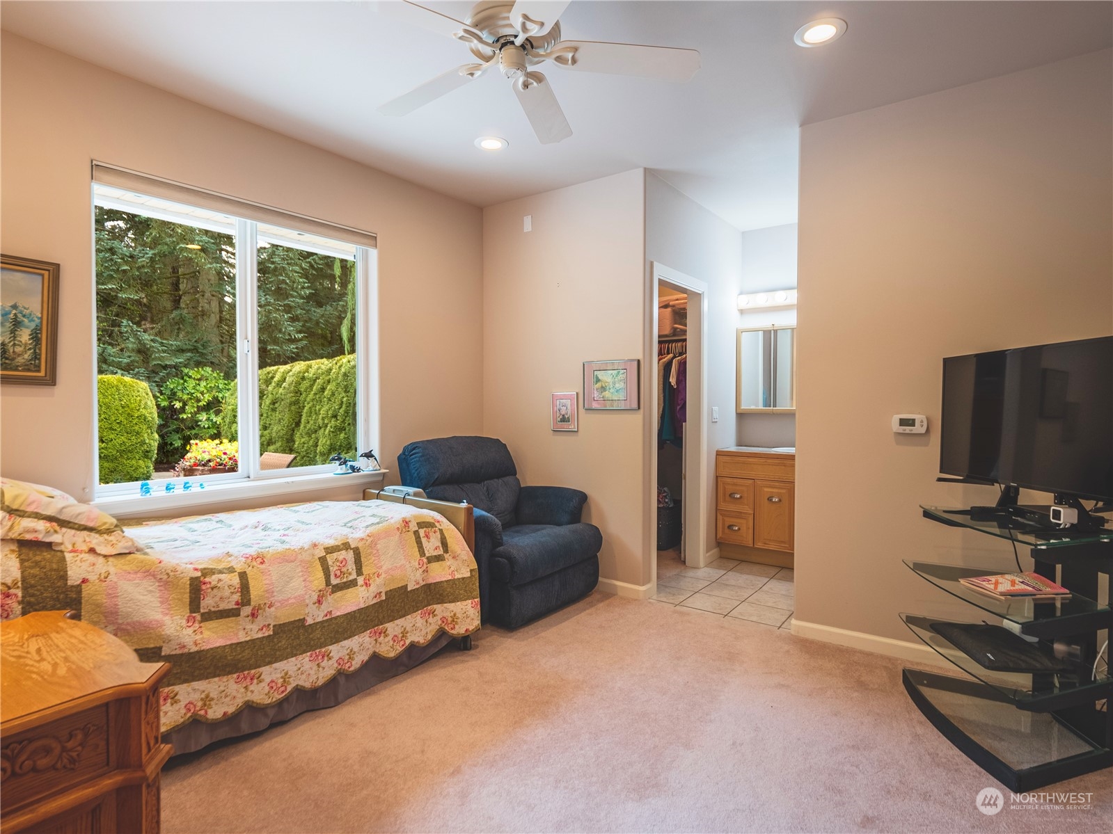 7801 Westlund Road Arlington, WA 98223 - Photo 16 of 39 a bedroom with a bed and a flat tv screen on dresser