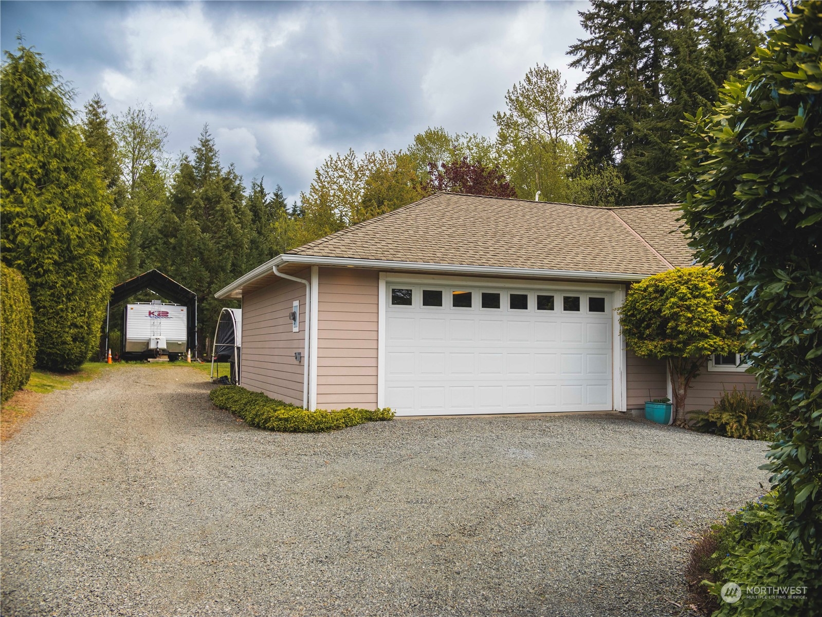 7801 Westlund Road Arlington, WA 98223 - Photo 33 of 39 a front view of a house with a yard and garage