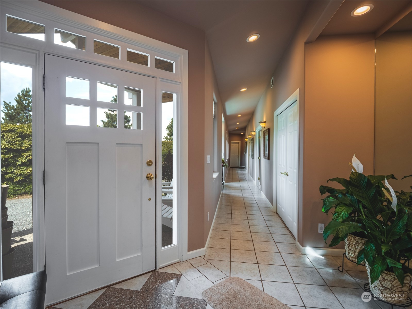 7801 Westlund Road Arlington, WA 98223 - Photo 4 of 39 a hallway with windows and flowers