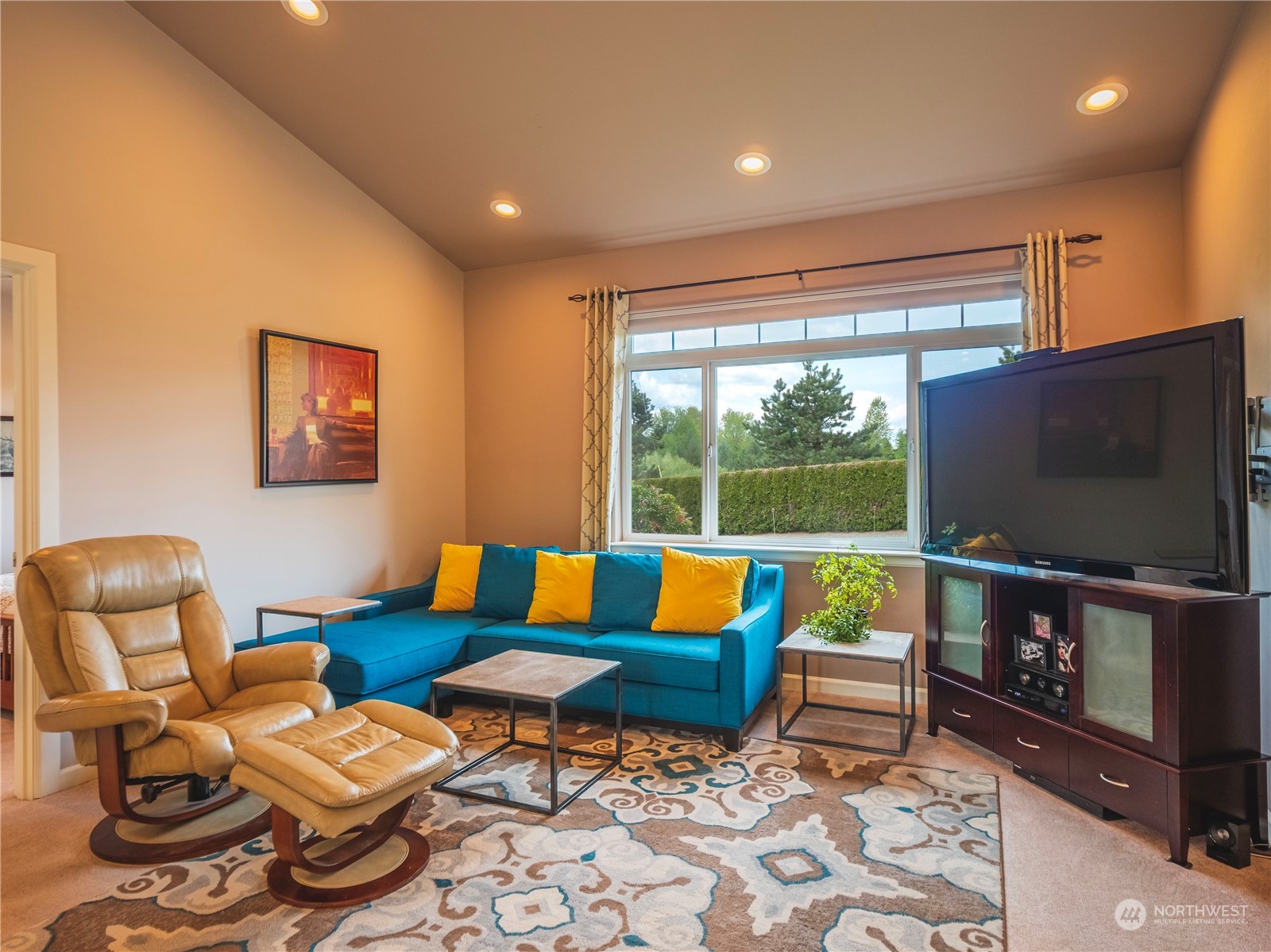 7801 Westlund Road Arlington, WA 98223 - Photo 7 of 39 a living room with furniture a flat screen tv and floor to ceiling window