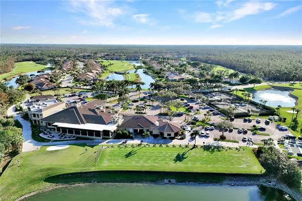 an aerial view of residential houses with outdoor space and river