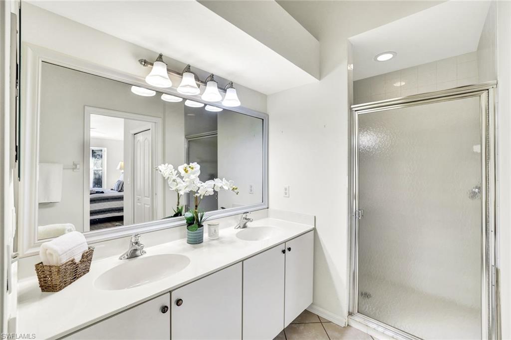 3715 Buttonwood Way, Unit 1722 Naples, FL 34112 - Photo 12 of 29 a bathroom with a double vanity sink mirror and shower
