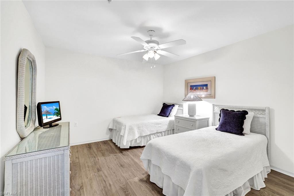 3715 Buttonwood Way, Unit 1722 Naples, FL 34112 - Photo 14 of 29 a bedroom with two beds and a flat screen tv