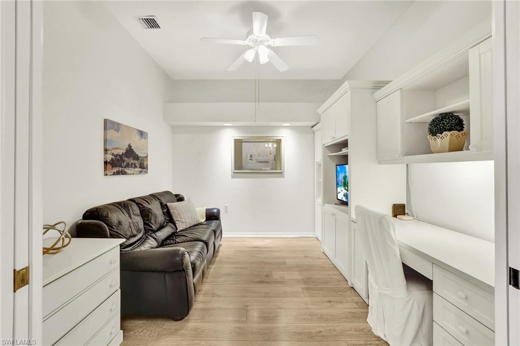 3715 Buttonwood Way, Unit 1722 Naples, FL 34112 - Photo 16 of 29 a living room with furniture and a wooden floor