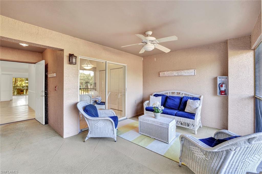 3715 Buttonwood Way, Unit 1722 Naples, FL 34112 - Photo 18 of 29 a living room with furniture and wooden floor