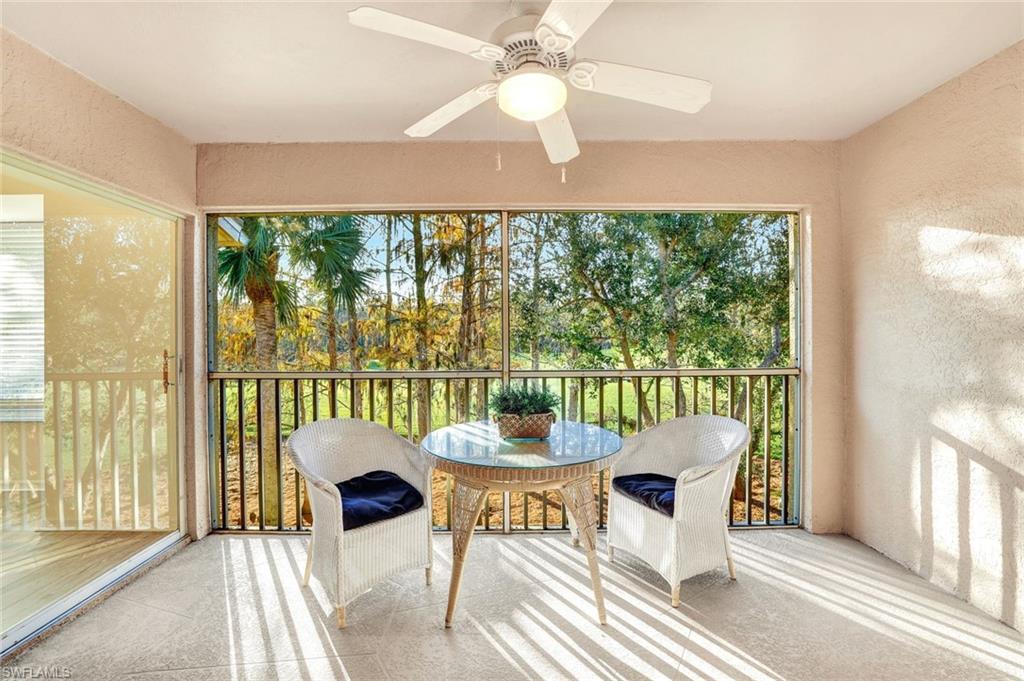 3715 Buttonwood Way, Unit 1722 Naples, FL 34112 - Photo 20 of 29 a dining room with furniture a chandelier and a floor to ceiling window