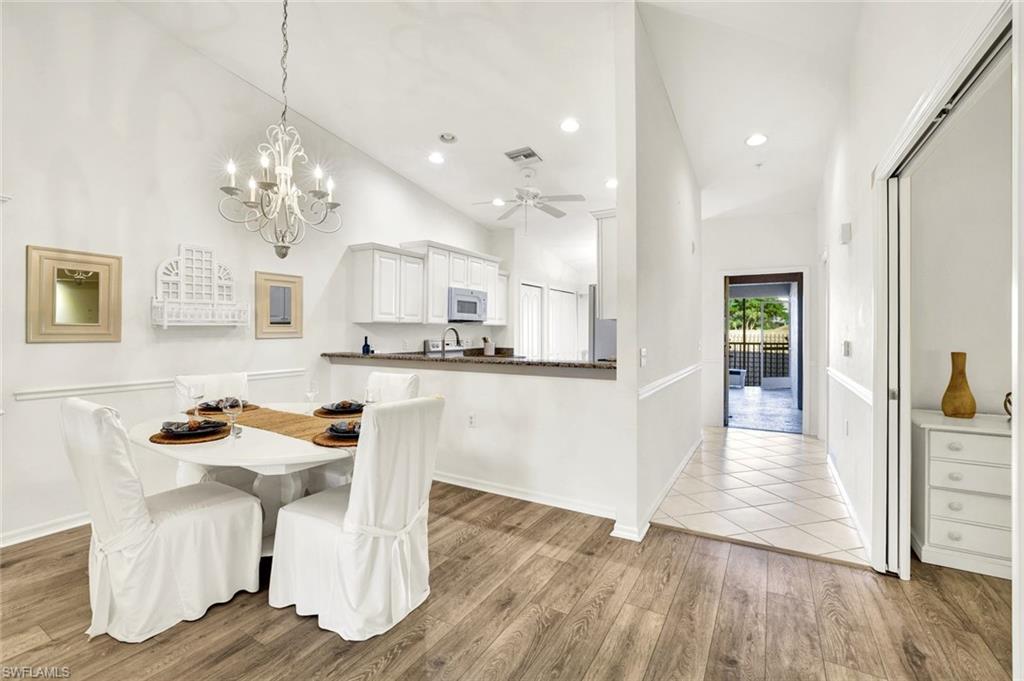3715 Buttonwood Way, Unit 1722 Naples, FL 34112 - Photo 2 of 29 a view of kitchen with furniture and wooden floor