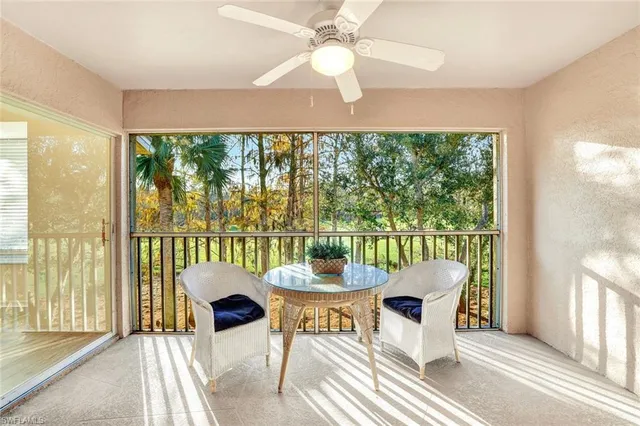 a dining room with furniture a chandelier and a floor to ceiling window