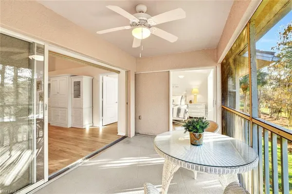 a dining room with furniture and a floor to ceiling window