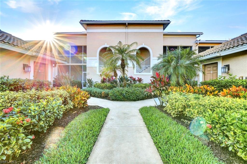 3715 Buttonwood Way, Unit 1722 Naples, FL 34112 - Photo 23 of 29 a front view of a house with garden