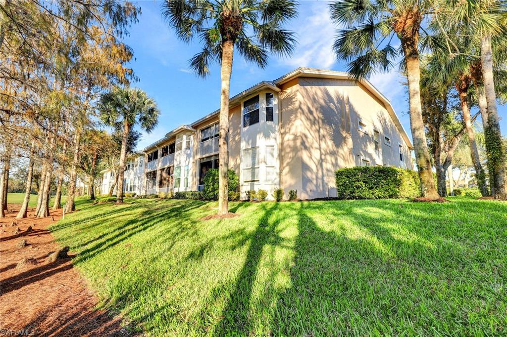 3715 Buttonwood Way, Unit 1722 Naples, FL 34112 - Photo 25 of 29 a view of a big yard with palm trees