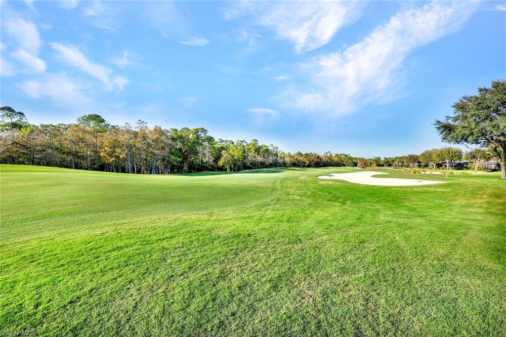 3715 Buttonwood Way, Unit 1722 Naples, FL 34112 - Photo 26 of 29 a view of a grassy field with an trees