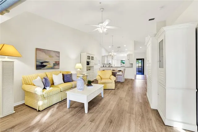 a living room with fireplace furniture and a wooden floor
