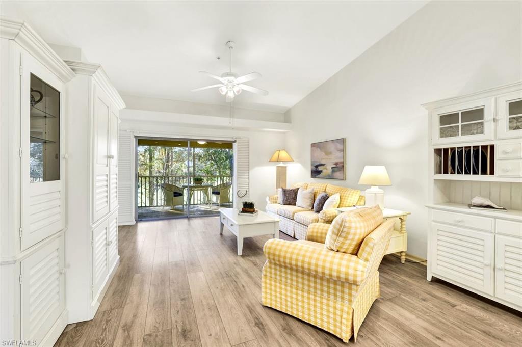 3715 Buttonwood Way, Unit 1722 Naples, FL 34112 - Photo 4 of 29 a living room with furniture and wooden floor