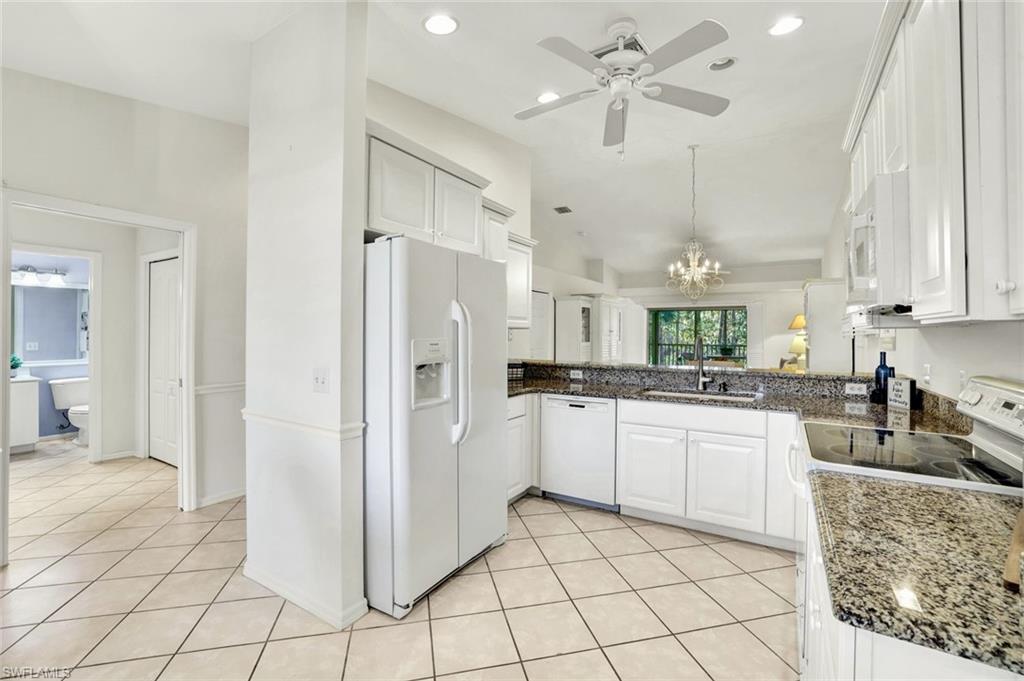 3715 Buttonwood Way, Unit 1722 Naples, FL 34112 - Photo 7 of 29 a kitchen with stainless steel appliances a refrigerator sink and cabinets