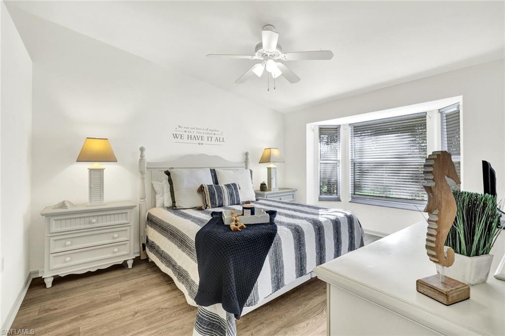 3715 Buttonwood Way, Unit 1722 Naples, FL 34112 - Photo 10 of 29 a living room with furniture and a chandelier