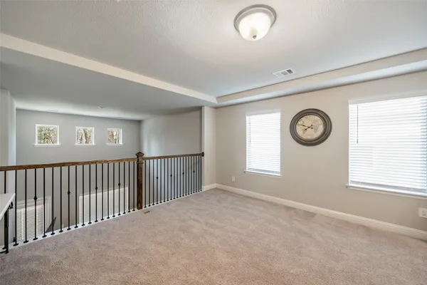 a view of empty room with windows and fan
