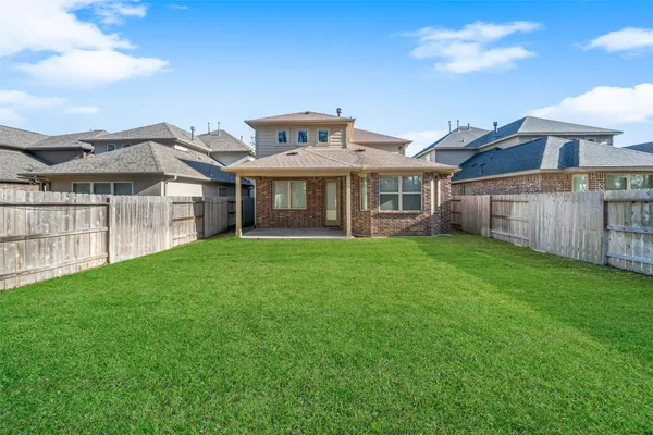 a view of a house with a yard and sitting area